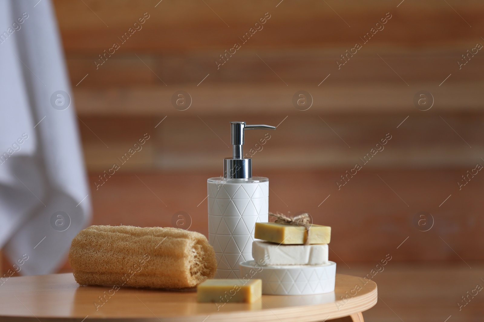 Photo of Composition with soap and toiletries on table against blurred background. Space for text