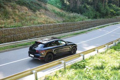 Picturesque view of asphalt road with modern black car outdoors