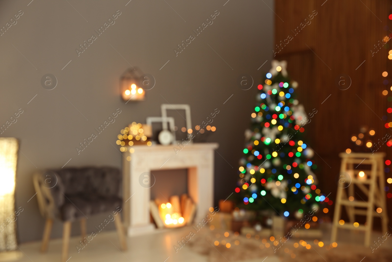 Photo of Blurred stylish room interior with Christmas tree and decorative fireplace