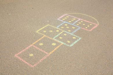 Hopscotch drawn with colorful chalk on asphalt outdoors