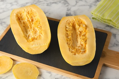 Photo of Ripe cut spaghetti squash on marble table