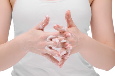 Woman with cleansing foam on hands against white background, closeup