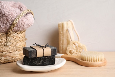 Photo of Composition with natural tar soap on wooden table