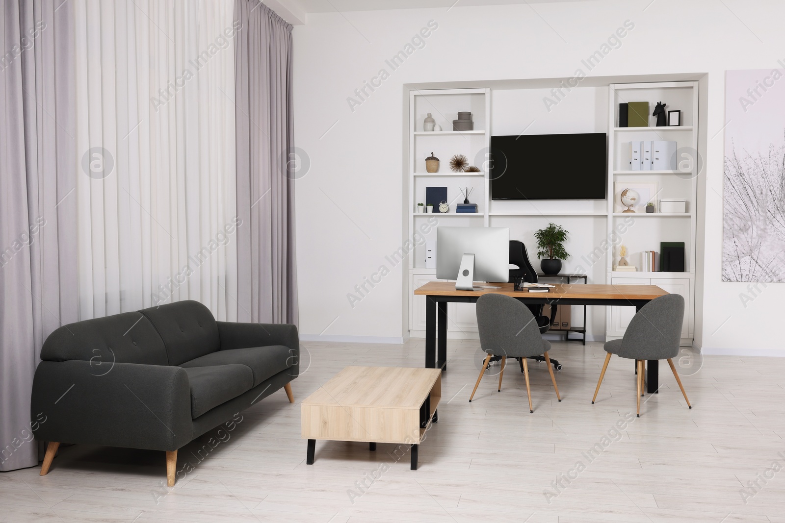 Photo of Stylish director's workplace with comfortable furniture and tv zone in room. Interior design