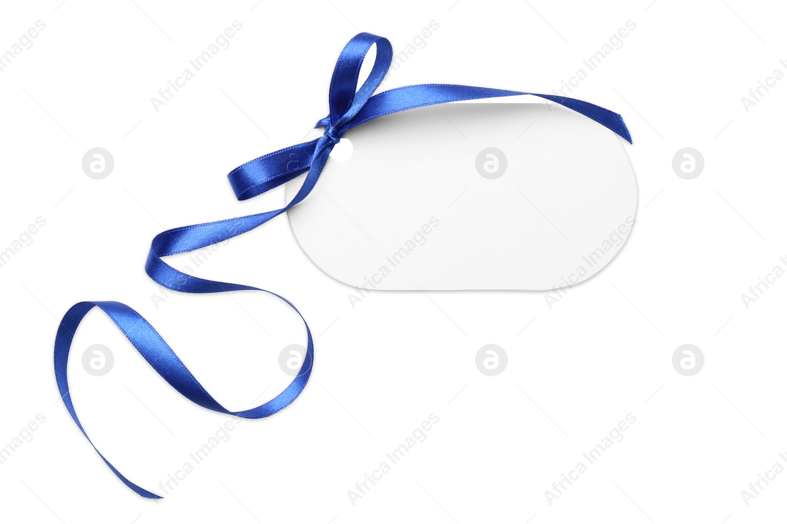 Photo of Blank gift tag with satin ribbon on white background, top view