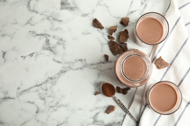 Photo of Flat lay composition with tasty chocolate milk and space for text on marble background. Dairy drink