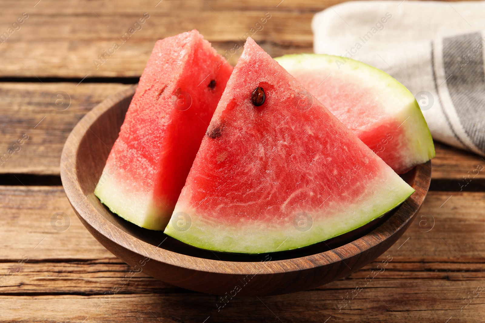 Photo of Delicious fresh watermelon slices on wooden table, closeup