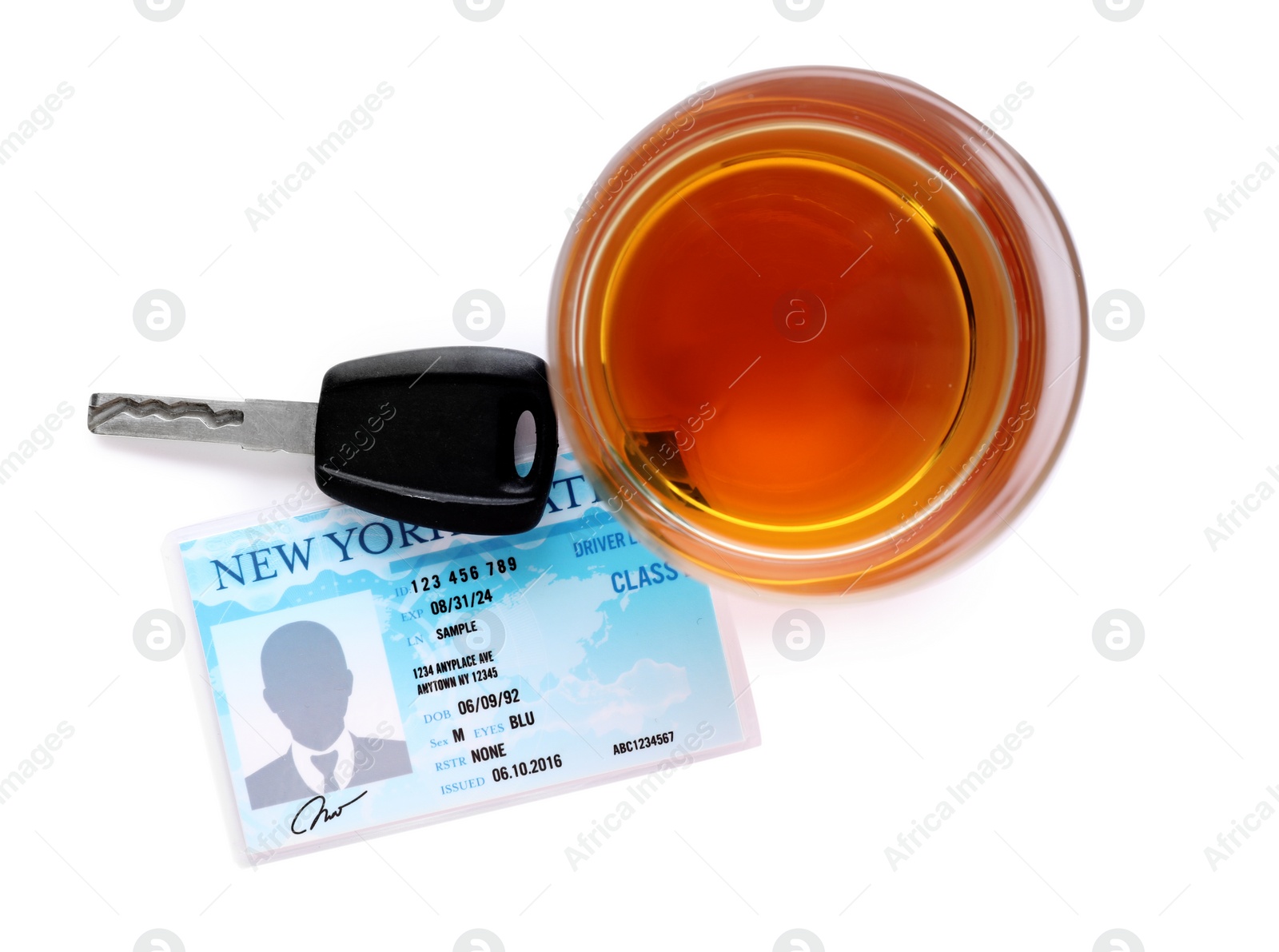 Photo of Glass of alcohol, car key and driver license on white background, top view. Responsible driving concept