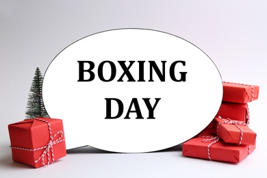 Photo of Speech bubble with phrase BOXING DAY and Christmas decorations on white background