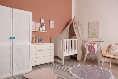 Baby room interior with stylish furniture and comfortable crib