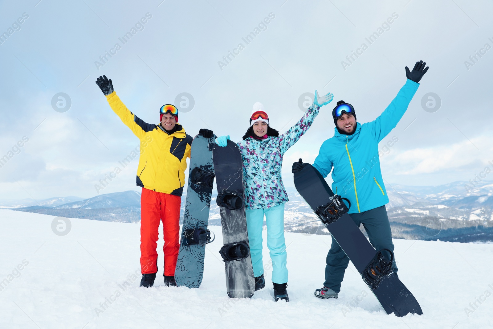 Photo of Group of friends with equipment in snowy mountains. Winter vacation