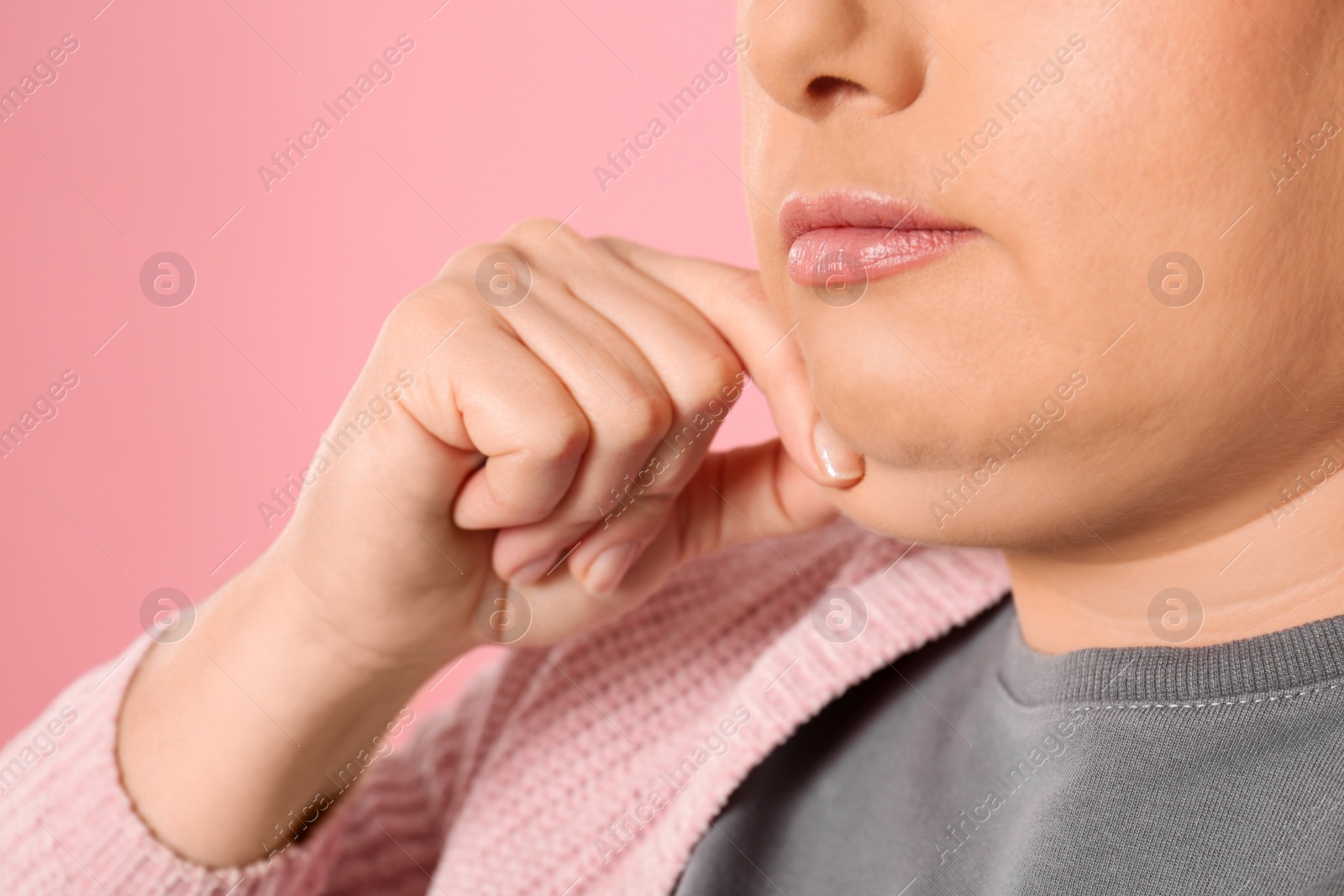 Photo of Woman with double chin on pink background, closeup