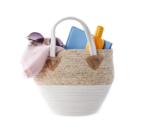 Bag with different beach objects on white background