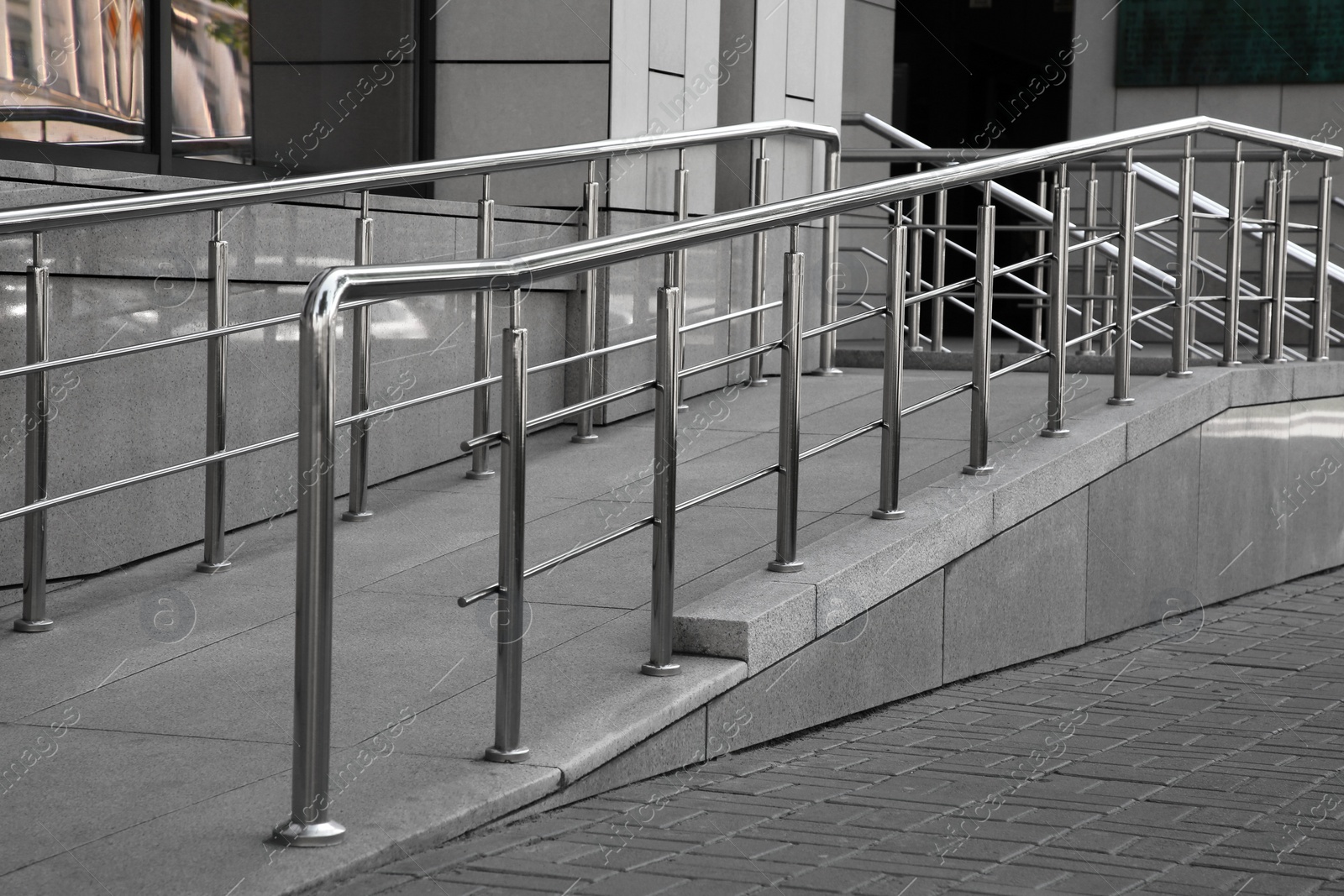 Photo of Ramp with metal handrails near building outdoors