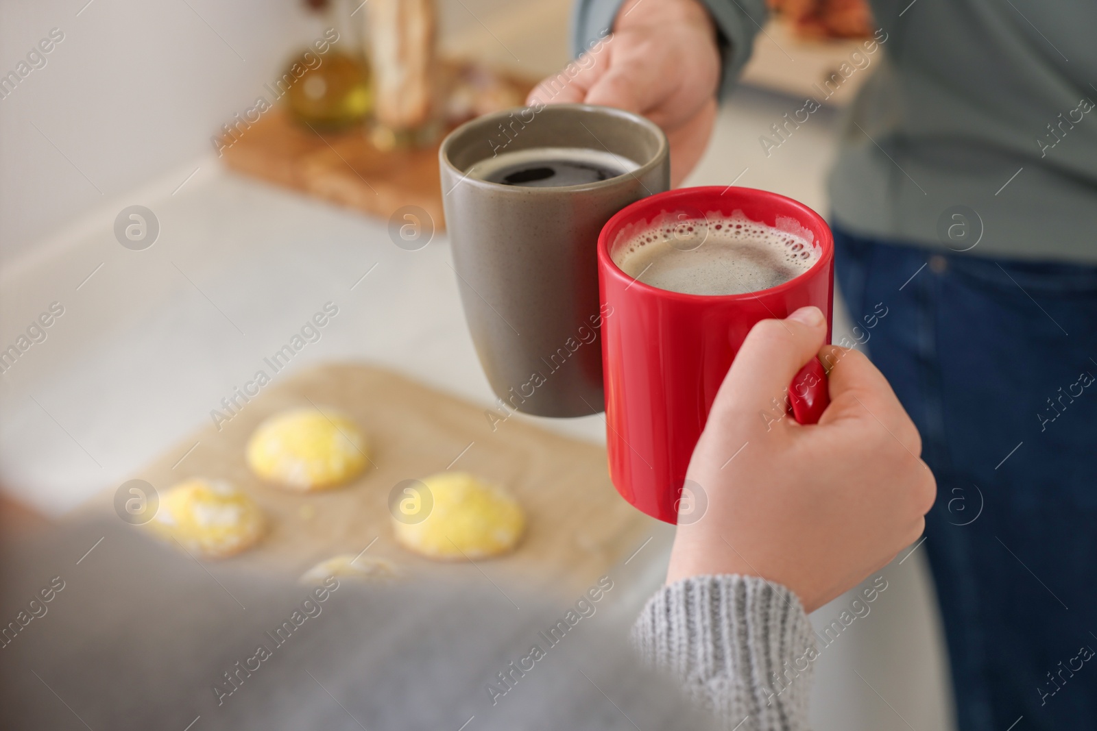 Photo of Couple drinking coffee at home, closeup. Space for text