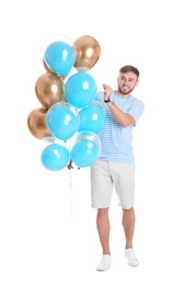 Young man with air balloons on white background