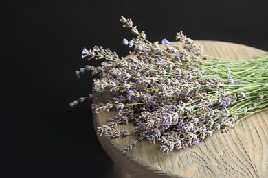 Photo of Beautiful blooming lavender flowers on wooden table