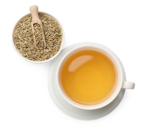 Photo of Aromatic fennel tea in cup, seeds and scoop isolated on white, top view