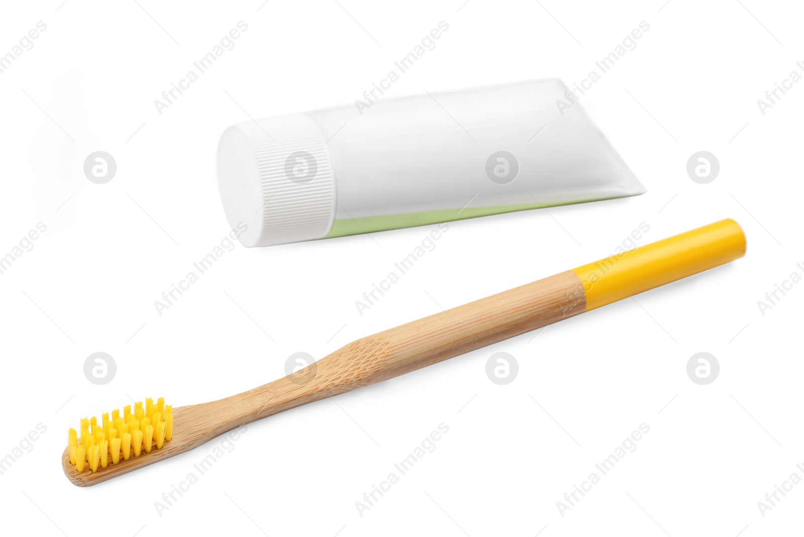 Photo of Bamboo toothbrush and paste isolated on white