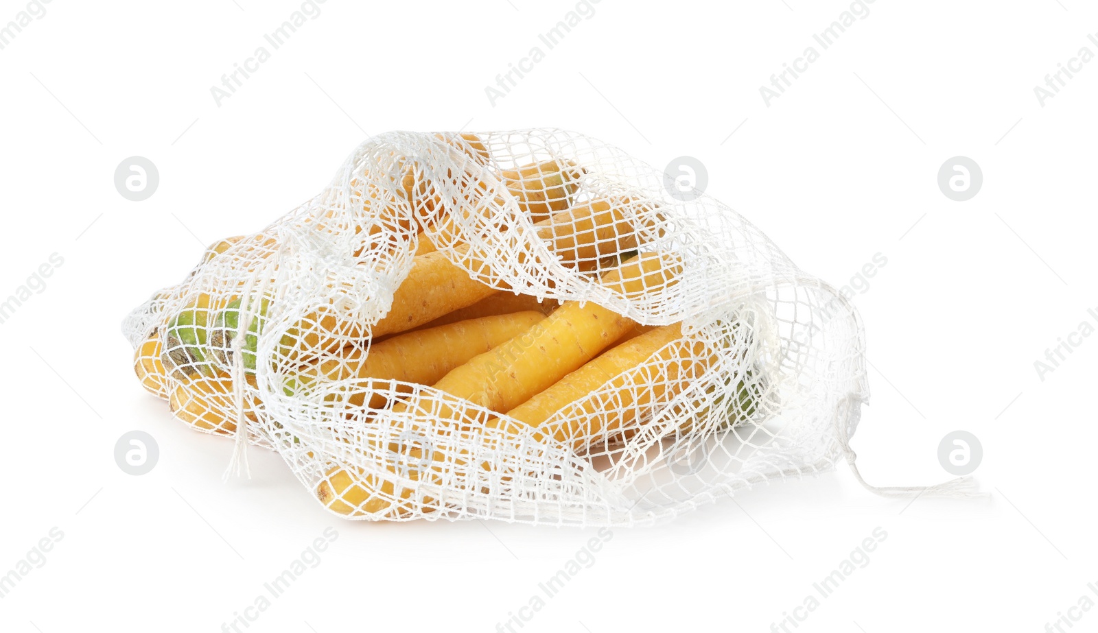 Photo of Raw yellow carrots in mesh bag isolated on white