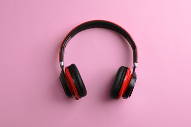 Photo of Wireless headphones on color background, top view