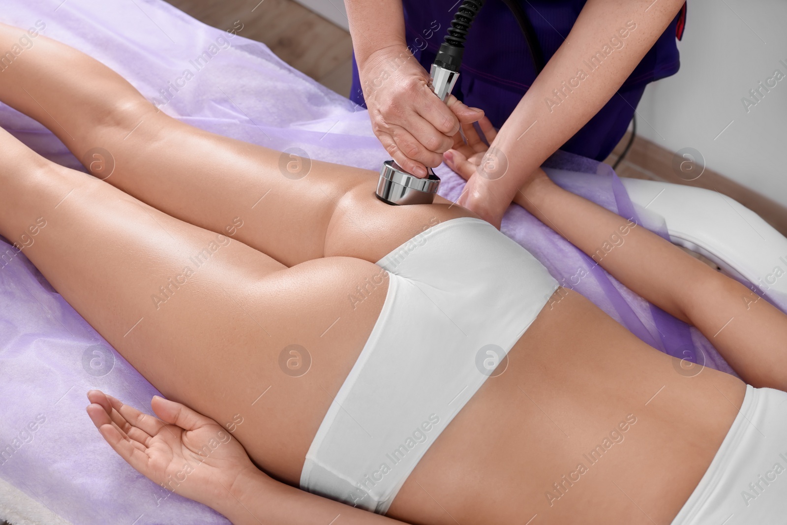 Photo of Woman undergoing radio frequency lifting procedure in beauty salon, closeup