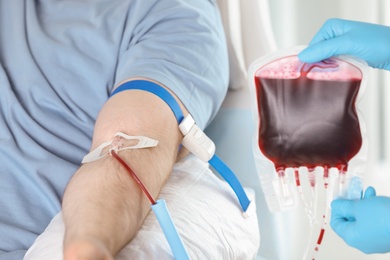 Photo of Man donating blood to save someone's life in hospital