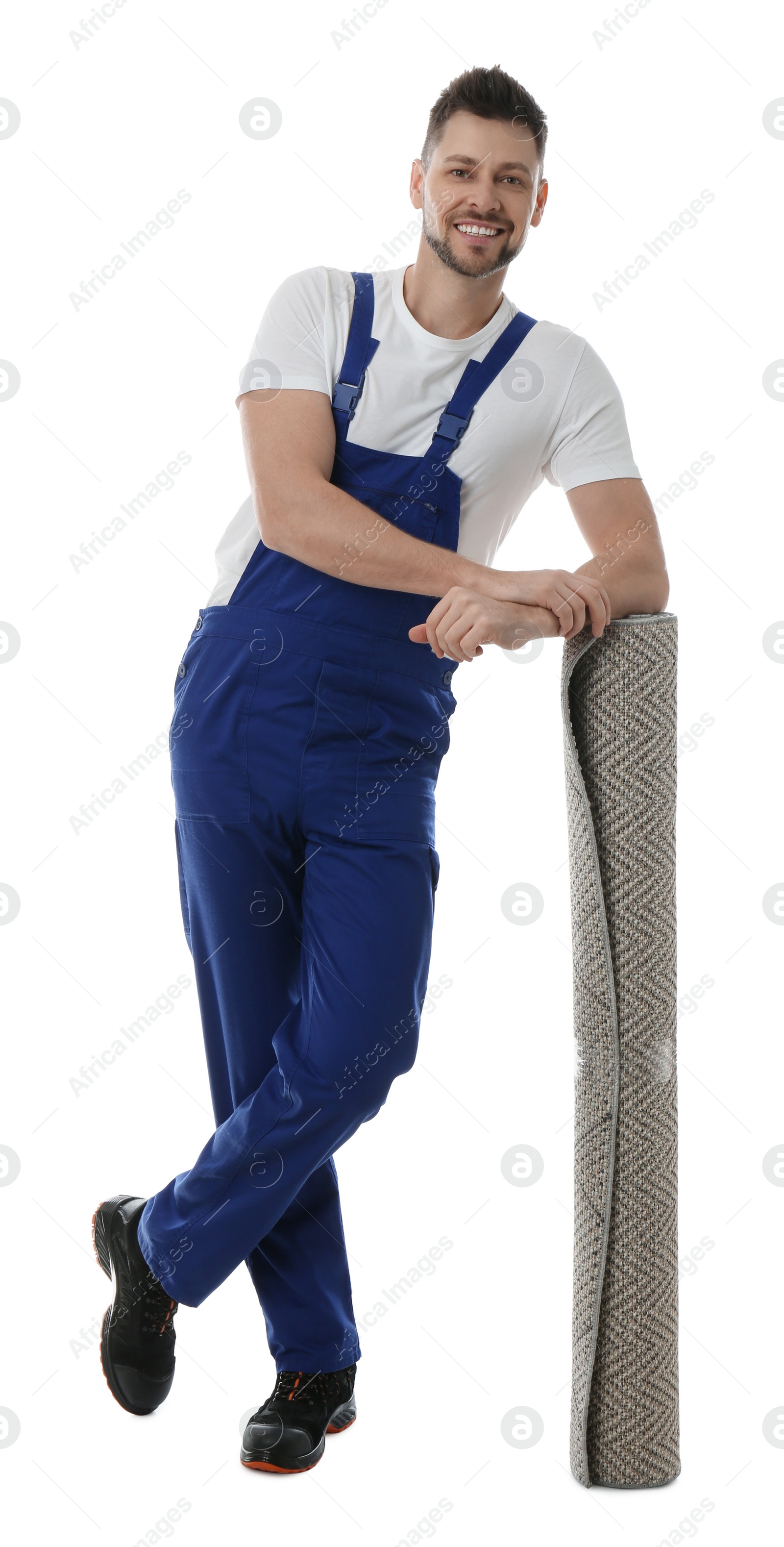 Photo of Male worker with rolled carpet on white background