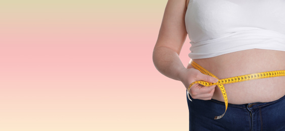 Image of Closeup view of overweight woman with measuring tape on color background, space for text. Banner design