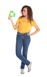 Young African-American woman with recycling symbol on white background