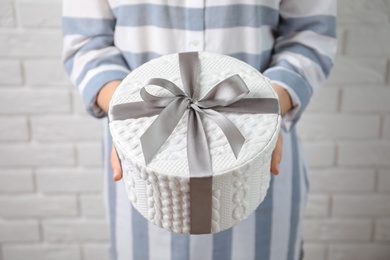 Woman holding beautiful gift box, closeup