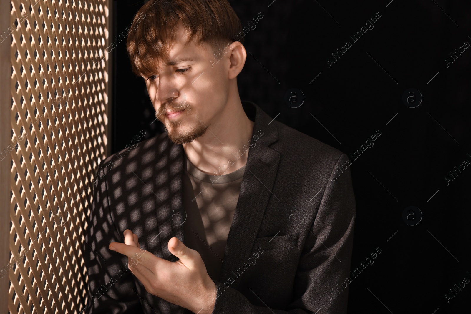Photo of Upset young man during confession in booth