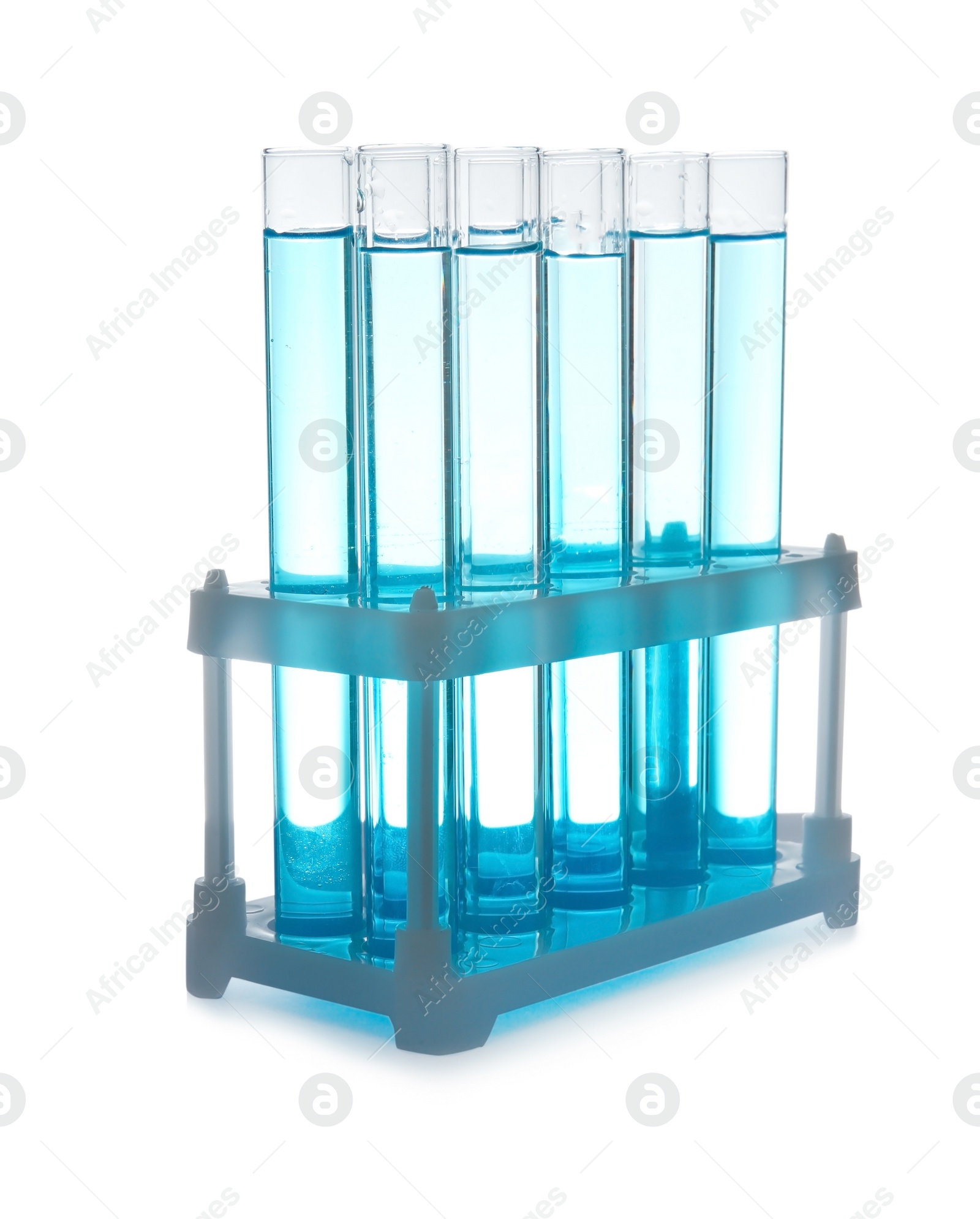 Photo of Test tubes with liquid in holder on table against white background. Laboratory analysis