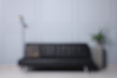 Photo of Blurred view of stylish living room interior with cozy sofa