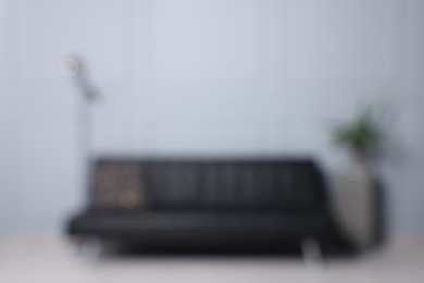 Blurred view of stylish living room interior with cozy sofa