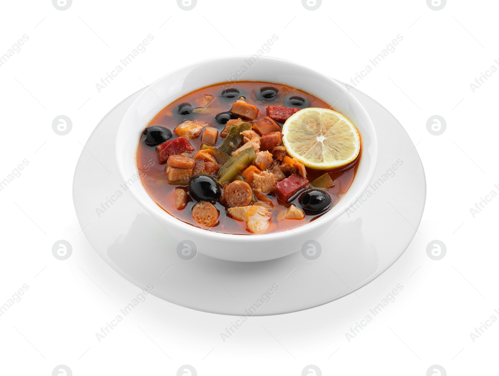 Photo of Meat solyanka soup with sausages, olives and vegetables in bowl isolated on white