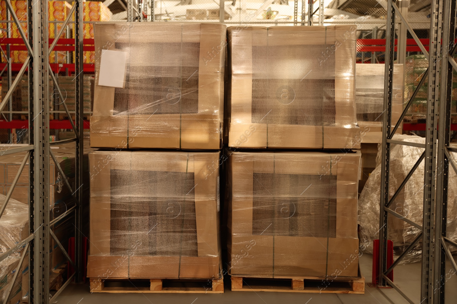 Photo of Warehouse with boxes on wooden pallets. Wholesaling