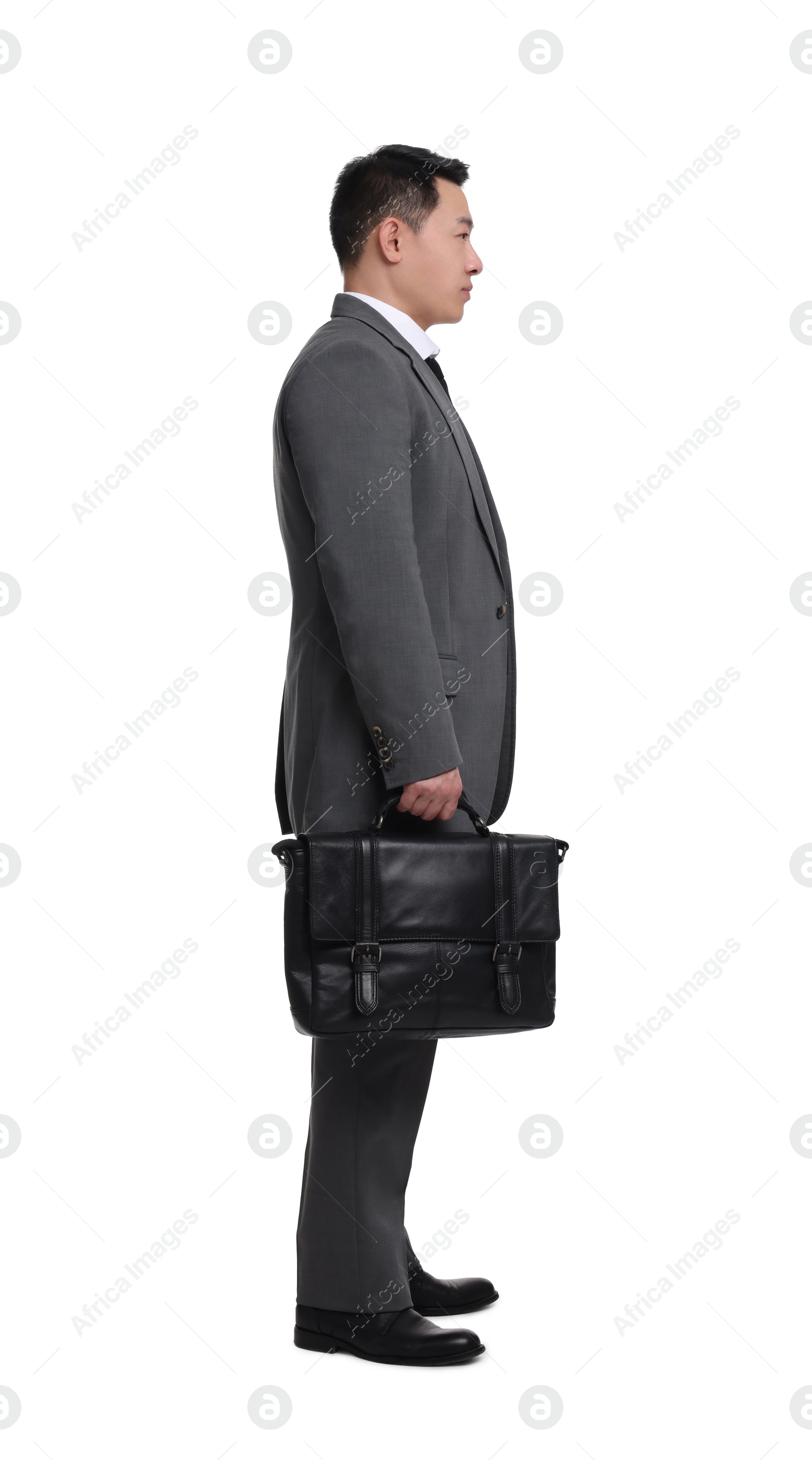 Photo of Businessman with briefcase posing on white background