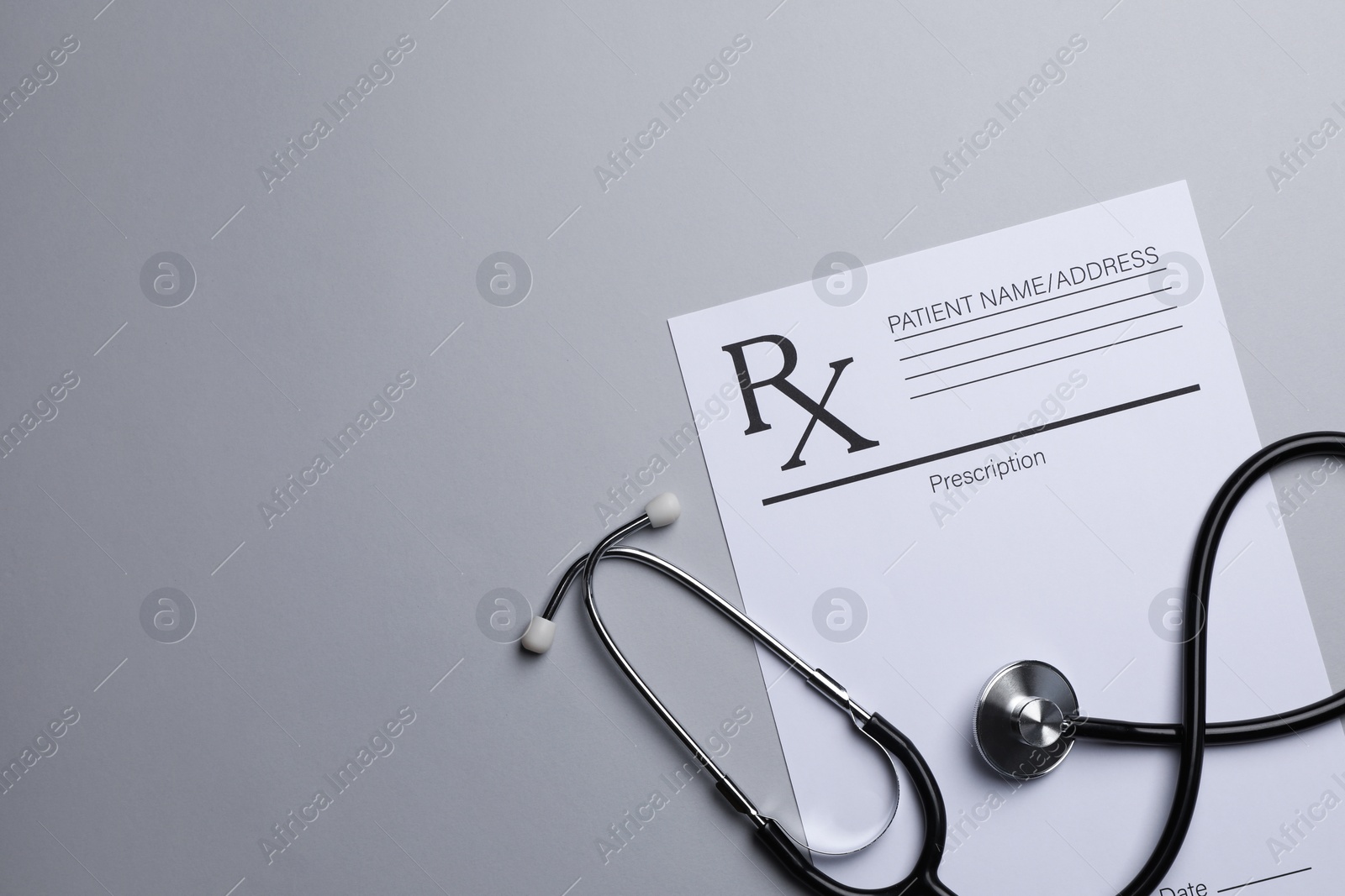 Photo of Medical prescription form and stethoscope on light grey background, flat lay. Space for text