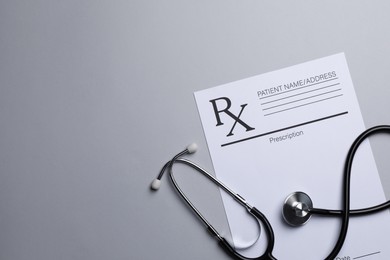 Photo of Medical prescription form and stethoscope on light grey background, flat lay. Space for text