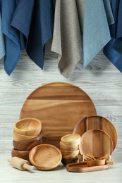 Photo of Set of clean wooden dishware and utensils on table