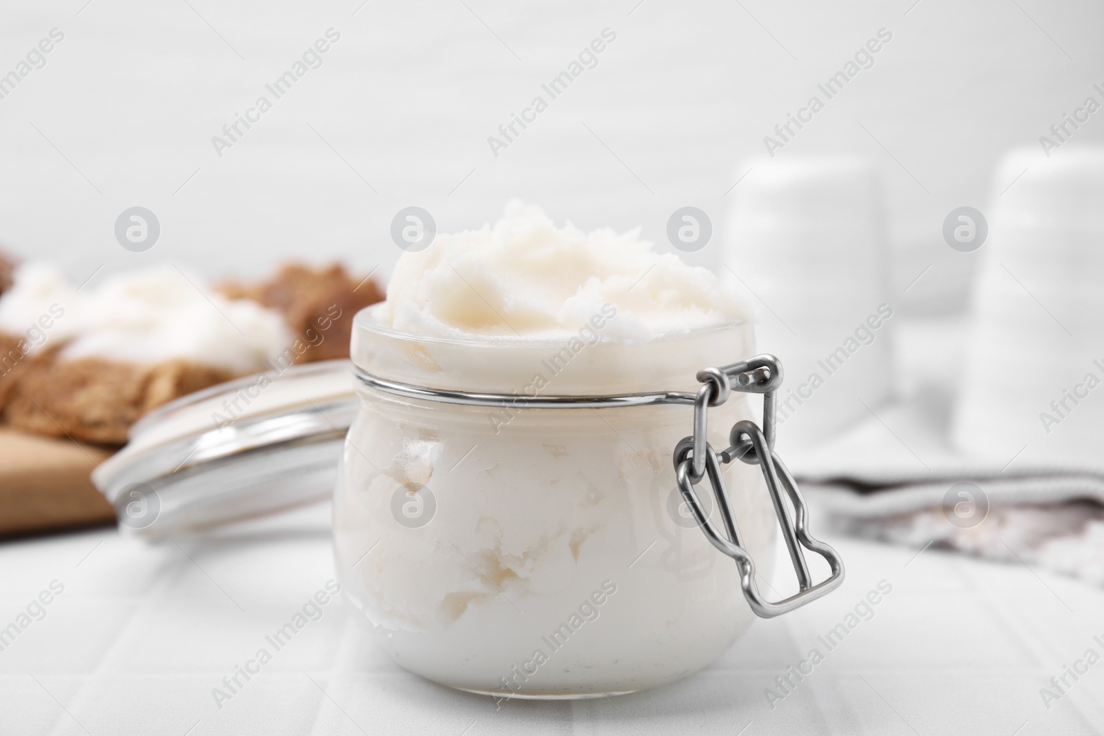 Photo of Delicious pork lard in glass jar on white table, closeup