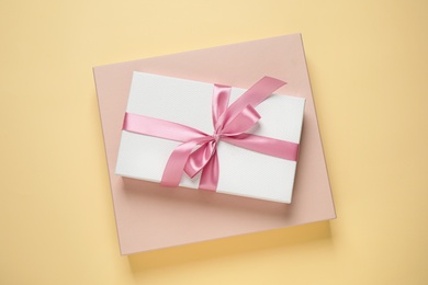 Photo of Beautiful gift boxes on beige background, top view