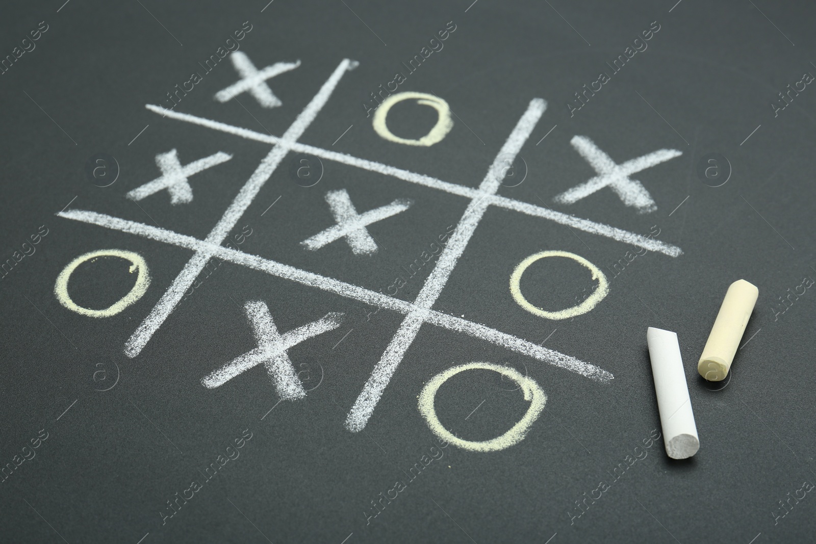 Photo of Tic tac toe game drawn on chalkboard