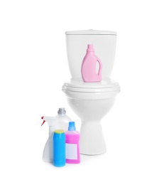 Photo of New ceramic toilet bowl and bottles of detergent on white background