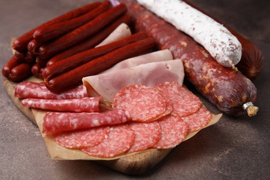 Photo of Different types of sausages on brown table