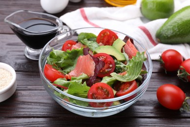 Photo of Vegetable salad with soy sauce on wooden table, closeup