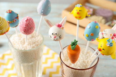 Delicious sweet cake pops for Easter celebration on table, closeup