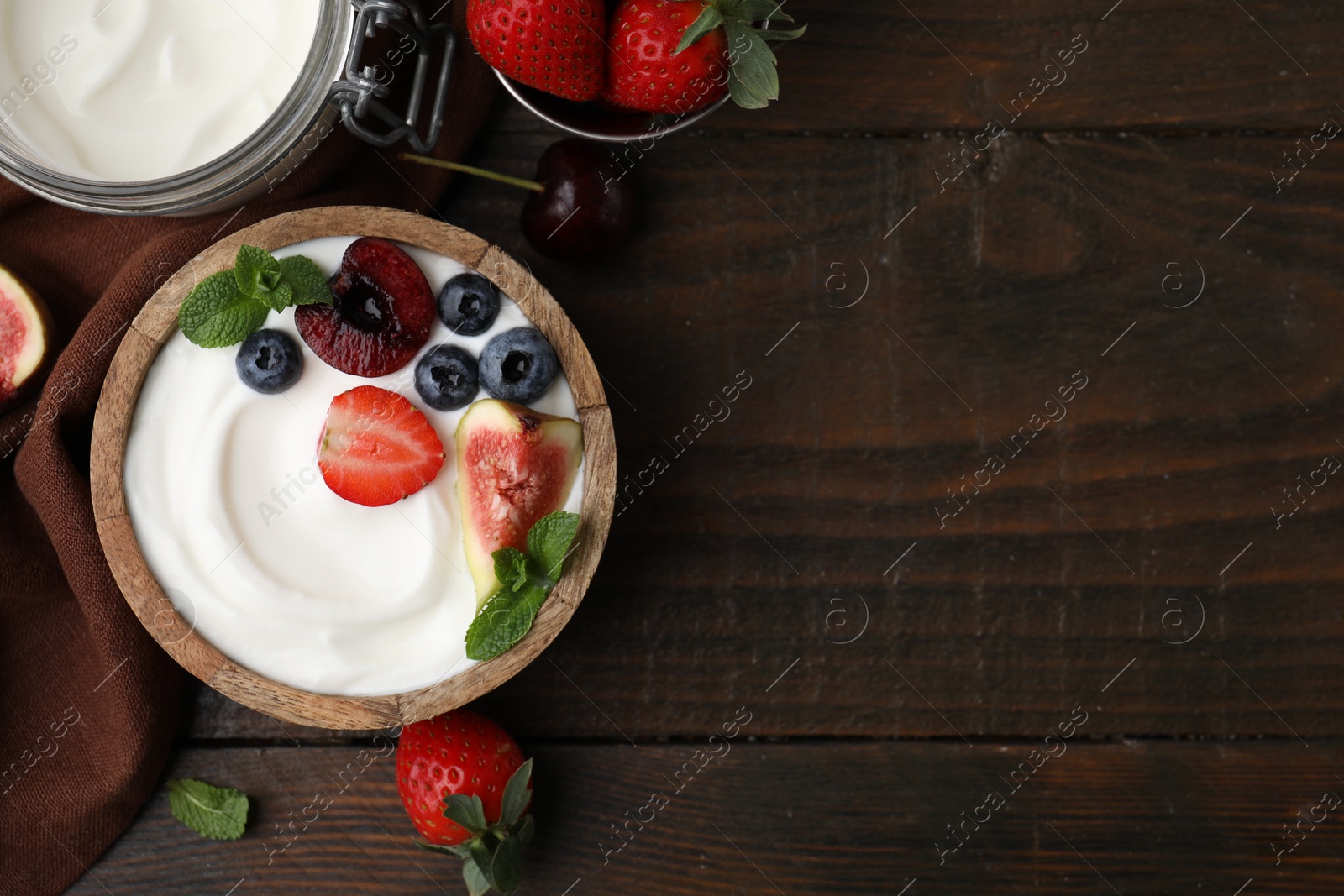 Photo of Tasty yogurt, berries, fruits and mint on wooden table, flat lay. Space for text