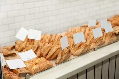 Fresh pastries on counter in bakery store. Space for text